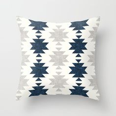 a blue and white pillow with an abstract design on it's back side,