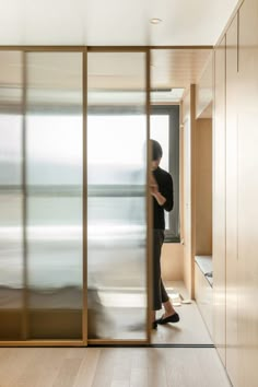 a person standing in front of a sliding glass door