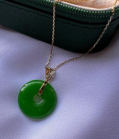 Embrace timeless elegance with this exquisite 14-carat gold-plated Jade round pendant necklace. The rich green  Jade gemstone is beautifully complemented by the luxurious gold plating, creating a piece that's both eye-catching and sophisticated. Perfect for any occasion, this necklace is designed to bring a touch of nature's beauty to your everyday wardrobe. Whether you're looking to elevate your own style or searching for the perfect gift, this necklace is a stunning choice. Crafted for durability and comfort, it's an affordable way to add a touch of luxury to your jewelry collection. Features: *14K gold-plated chain and setting for a luxurious look. * Jade gemstone with a classic round pendant design. *Versatile piece, ideal for layering or wearing alone.  *Perfect for gifting or treatin Luxury Oval Pendant Jade Necklace, Jade Accessories, Donut Necklace, Lucky Necklace, Jade Pendant Necklace, Astoria Ny, Donut Pendant, Jade Gemstone, Round Pendant Necklace