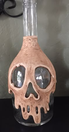 a glass bottle with a fake skull in it