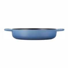 a blue casserole dish on a white background