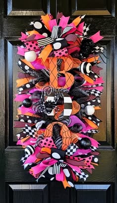 a colorful halloween wreath hanging on the front door