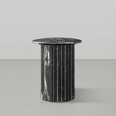 a black and white marble table sitting on top of a gray floor