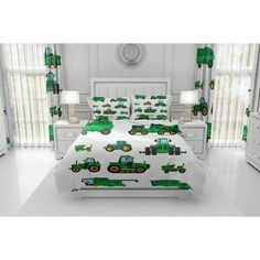 a bed room with a neatly made bed and green tractors on it