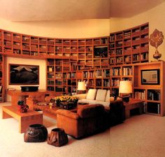 a living room filled with lots of wooden bookshelves