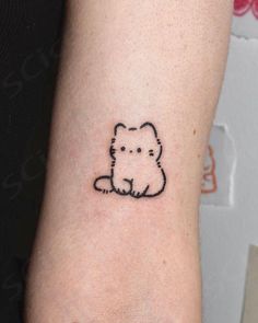 a small dog tattoo on the left inner arm and wrist, which is drawn in black ink