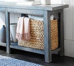 a wooden table with baskets and towels on it