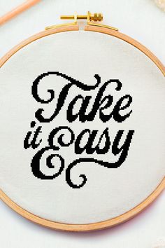 a cross - stitch pattern with the words take it easy in black and white letters