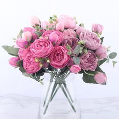 a vase filled with pink flowers on top of a table