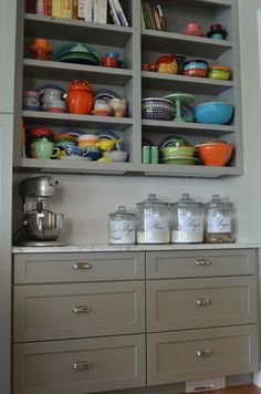 an open cabinet with lots of dishes on it