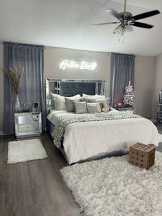 a bedroom with a large bed and white rugs