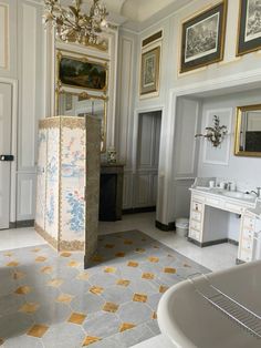 an ornate bathroom with gold and white decor