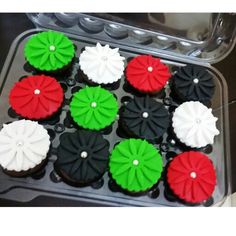 cupcakes decorated with red, white and green icing in a muffin tin