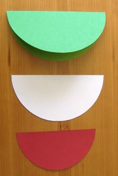 three pieces of paper cut out to look like shapes