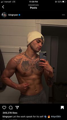 a shirtless man taking a selfie in the mirror with his cell phone and wearing a hat