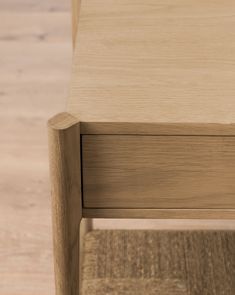 a close up of a wooden table on a hard wood flooring area with no one around it