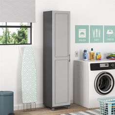 a washer sitting next to a dryer in a room with pictures on the wall