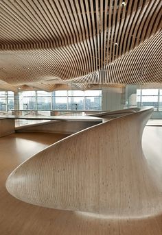 an empty skate park with wooden slats on the ceiling