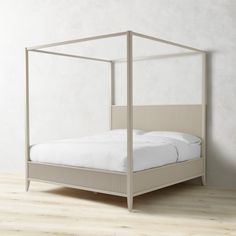 a bed that is sitting on top of a hard wood floor next to a wall