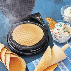 some waffles and ice cream are on a blue table with other food items