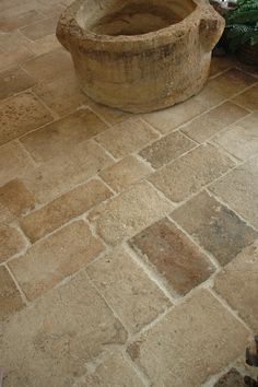 a planter sitting on top of a stone floor