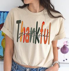 "Thanksgiving Family Shirt, Thankful Grateful Blessed shirt,Thanksgiving Gift, women thanksgiving shirt, fall love shirt, Thankful shirt, Thankful Family Shirts,Cute Thanksgiving Shirt"    Introducing our beautifully designed "Thankful Grateful Blessed" shirt, perfect for expressing your gratitude and blessings in style. This comfortable and trendy shirt is a must-have addition to your wardrobe, whether you're dressing up for a special occasion or keeping it casual for everyday wear. Handcrafted with love and care, this unique shirt is not only a statement piece but also a testament to the creativity and authenticity that Etsy stands for  OUR RANGE OF T-SHIRTS and SWEATSHIRTS: ✔Original Designs: We pride ourselves on offering unique designs, created by our talented team of artists. From bo Thankful Grateful Blessed Shirt, Fall Love, Blessed Shirt, Thankful Shirt, Thankful Grateful Blessed, Thanksgiving Family, Grateful Thankful Blessed, Thanksgiving Shirt, Family Shirt