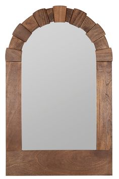 a wooden mirror with an arch shaped frame