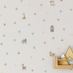 an animal themed nursery wallpaper with animals and triangles on it's white walls