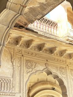 an arch in the side of a building with a clock on it