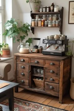 an old wooden cabinet with coffee maker and potted plants on it in a living room