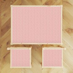 two pink chairs sitting on top of a wooden floor