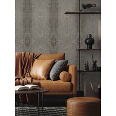 a living room with a brown leather couch and book shelf on the wall next to it