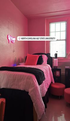 a bedroom with pink walls and black furniture