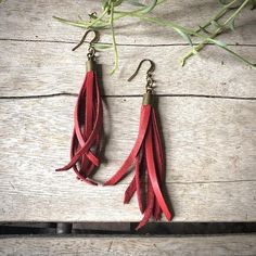 -These tassel earrings are made from soft red deerskin leather.  Part Western, part Boho, part Rock 'n Roll, these little fringe earrings give a big kick to any outfit.-Lightweight enough to wear every day. -3" - 3.5" total length, including earwires.-Earwires are antique-brass.-Deerskin leather is sustainably sourced in the USA.-Ok to get wet.-Available in 10 colors.-Designed and handmade in South Pasadena, CA.Check out more of our awesome earrings here:https://www.etsy.com/shop/ASTALIJewelry?r Adjustable Red Leather Earrings, Adjustable Leather Tassel Earrings, Red Leather Earrings, Creepy Earrings, Awesome Earrings, Jewelry Western, Fringe Earring, Tassel Earring, Leather Earring