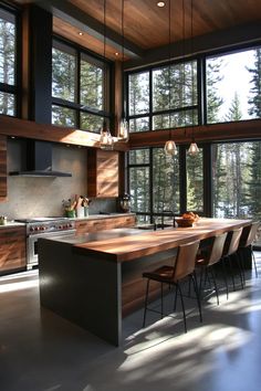 a large kitchen with an island counter top and lots of lights hanging from the ceiling