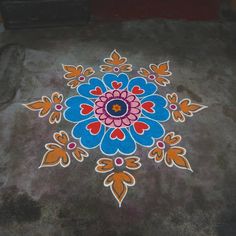 a colorful flower design painted on the ground