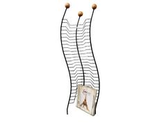 an iron rack with three balls hanging from it's sides and two pictures on each side