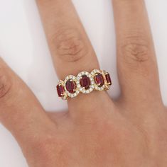 a woman's hand with a ring on it and three stones in the middle