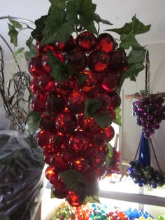 a vase filled with lots of red grapes