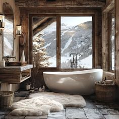 a bathroom with a large tub in the middle of it and a mountain view out the window