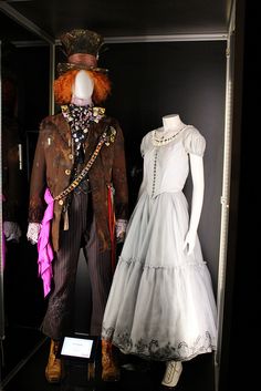 two mannequins dressed in costumes are displayed