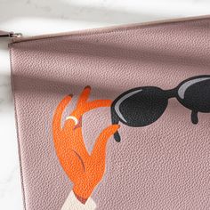 a pink purse with an orange fox and sunglasses on it