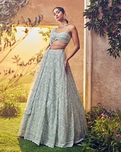 Featuring a mint green tulle lehenga embroidered fully by hand with various ornamental lustre sequences and Japanese bugle beads. It is paired with a scallop dupatta with crystal drops and blouse.From Aneesh Agarwaal's Ellora collection.DELIVERY TIMEPlease allow 8-12 weeks for your outfit to arrive.FABRIC DETAILSNetProfessional cleaning only. Tulle Lehenga, Wedding Fits, Satin Lehenga, Bridal Lehenga Online, Scallop Pattern, Desi Outfits, Organza Lehenga, Green Tulle, Draping Fashion