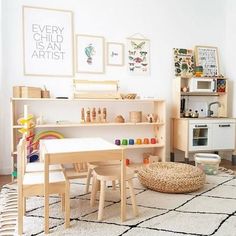 a child's playroom with wooden furniture and art work on the wall above it