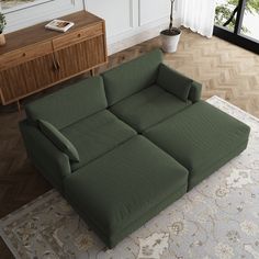 a green couch sitting on top of a rug