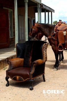 two horses standing next to each other in front of a building with an old chair