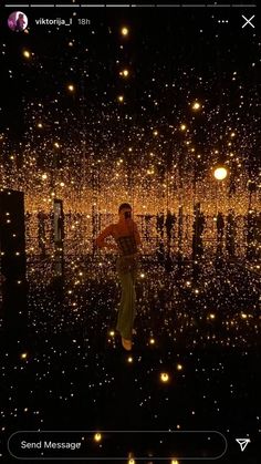 a man standing in the middle of a room filled with lights and stars on it