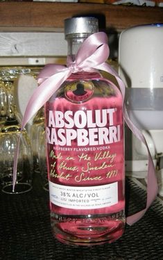 a bottle of absolut raspberry vodka with a pink ribbon tied around it