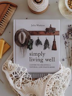 a book sitting on top of a white table next to other items and yarns