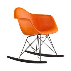 an orange rocking chair with black legs